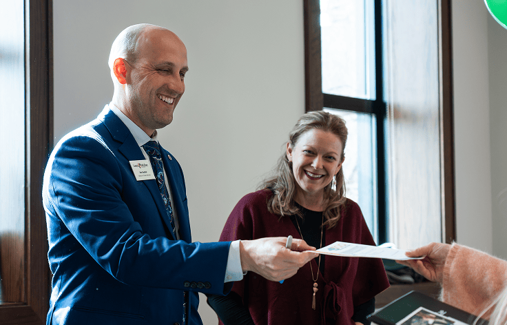 Man and women in snazzy business attire laughing