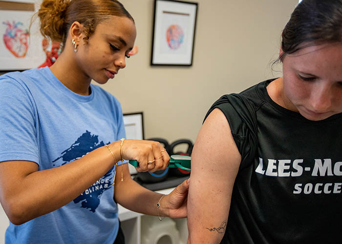 Student examines arm of a participant.