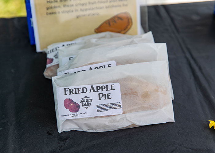 Packaged fried apple pies on a table at a local food stand